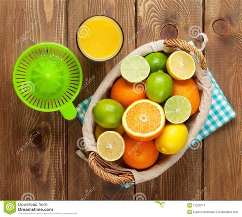Citrus Fruits And Glass Of Juice Oranges Limes And Lemons Stock Photo
