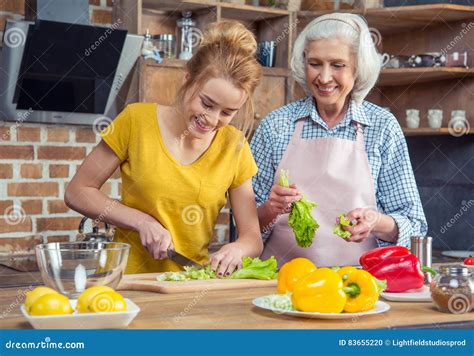 Granddaughter And Grandmother Cooking Together Stock Photo Image Of