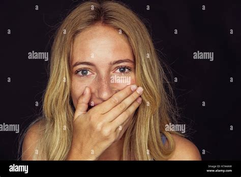 Young Woman Laughing With Hand Over Mouth Stock Photo Alamy