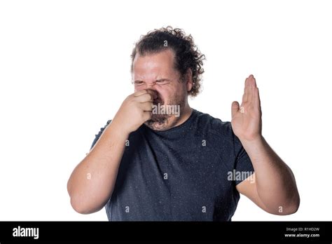 A Young Man Holds Or Pinches His Nose Shut Because Of A Stinky Smell Or