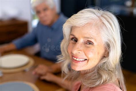 Close Up Portrait Of Smiling Caucasian Senior Woman Holding Biracial