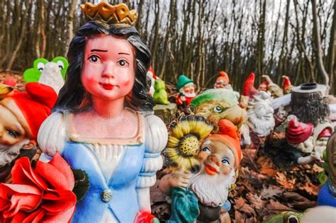 Colorful Snow White With Garden Gnomes At A Place In The Forest Stock