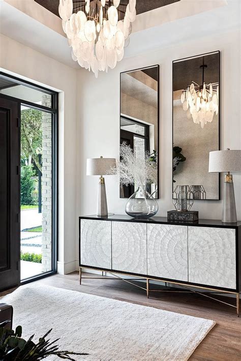 Modern Entryway Design With Luxurious Light Fixture And Styled Console