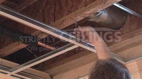 A dropped ceiling is a secondary ceiling, hung below the main (structural) ceiling. Install Grid and Track System in Basement - Drop Ceilings ...