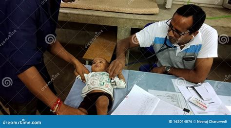 Government Hospital Doctor Checking Baby Boy Health On Table At