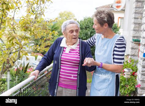 Home Care Aid Assisting Elderly Woman Dordogne France Stock Photo Alamy
