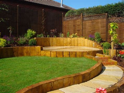 Lawn edging ideas can range from simple to bold designs. This sloped garden has curved landscaping with the slope ...