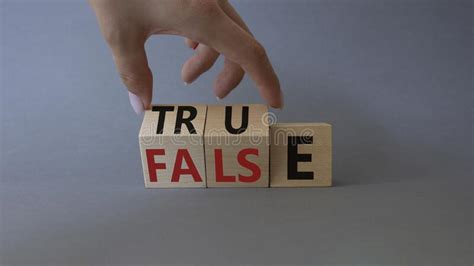 True Vs False Symbol Businessman Hand Turns Cubes And Changes Word