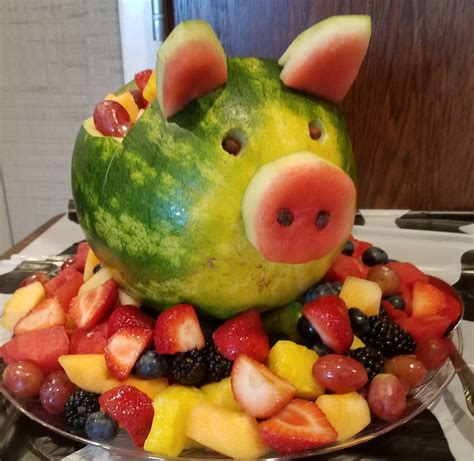 A Watermelon Shaped Like A Pig Sitting On Top Of Fruit