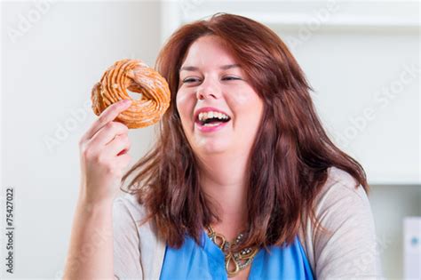 Happy Woman Eating Donuts At The Table Foto De Stock Adobe Stock