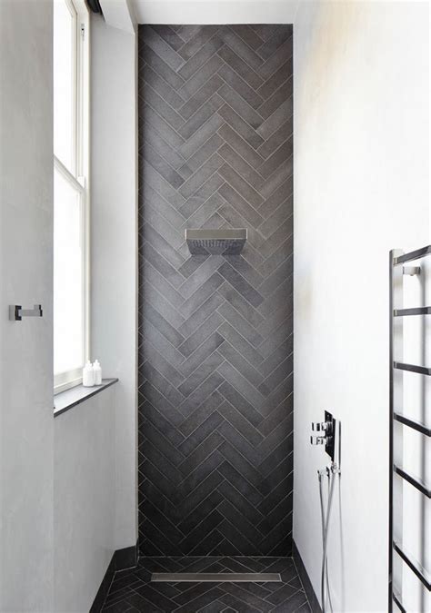 contemporary shower featuring herringbone tile decoist