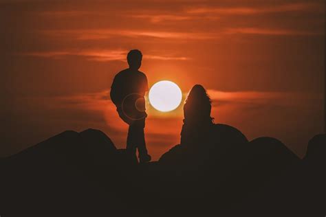 Silhouette Of Two People Looking At Sunset Photo Free Image On Unsplash