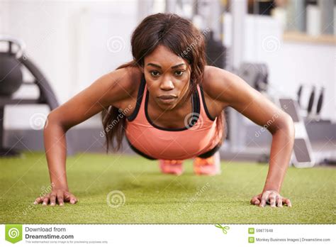 Young Woman Doing Push Ups At A Gym Stock Photo Image Of Power