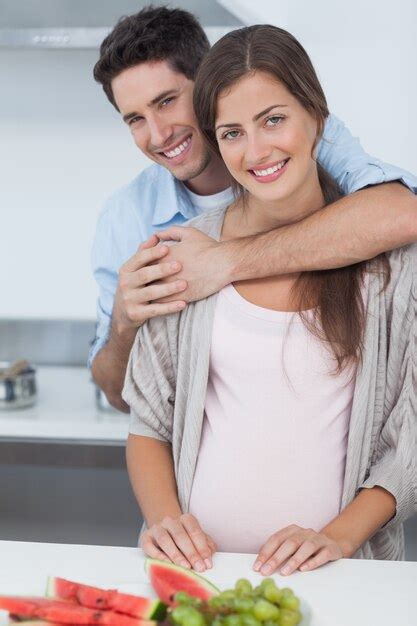 premium photo man embracing his pregnant wife