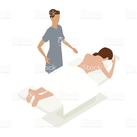 A Female Patient Rests On A Massage Table While A Female Massage