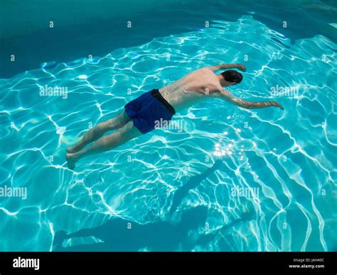 motionless body of swimmer drowned floating in swimming pool concept photo posed by model
