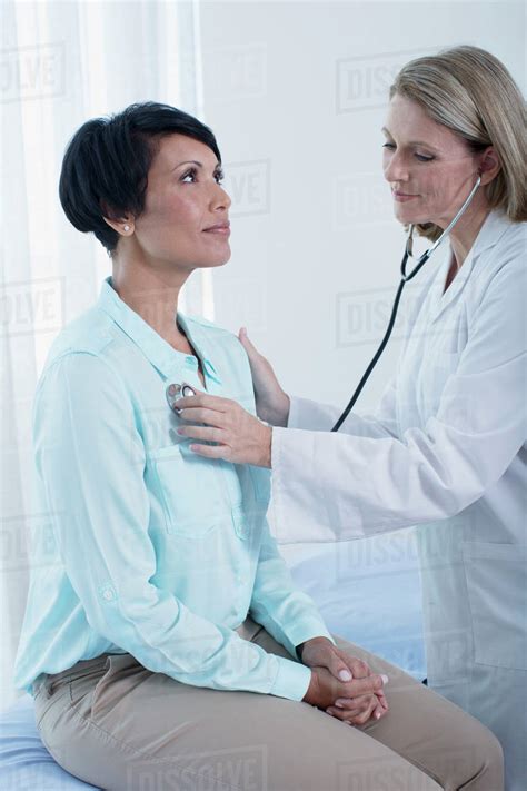 Female Doctor Examining Her Patient With Stethoscope In Office Stock Photo Dissolve