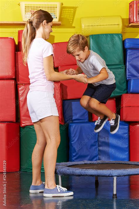 Boy Jumping On Trampoline In Gym Stock Photo Adobe Stock