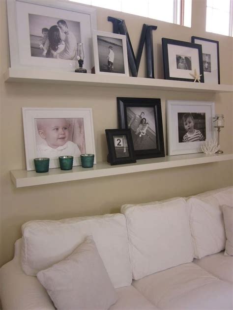 A White Couch Sitting Next To A Wall Filled With Pictures And Framed