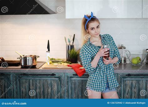 A Cute Young Girl In The Kitchen Prepares Food Stock Photo Image Of