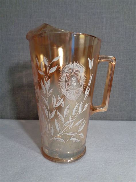 Jeanette Iridescent Marigold Carnival Glass Pitcher White Etsy Carnival Glass White Cosmo