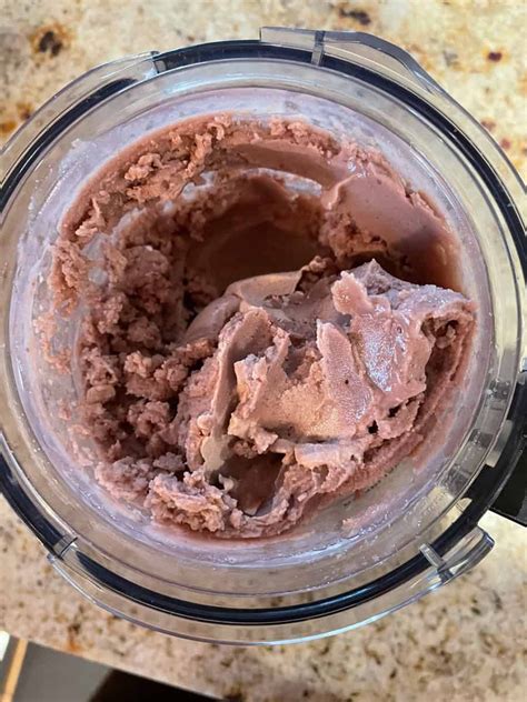 A Blender Filled With Chocolate Ice Cream On Top Of A Counter
