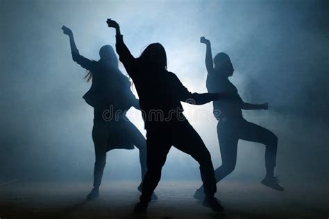 Group Of Young Female Dancers On The Street At Night Stock Photo