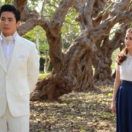 In the car, on the way from the main gates, she sees a handsome man dressed in a white suit watching her from behind the trees. Tae Pang Korn (2017) - Photos - MyDramaList
