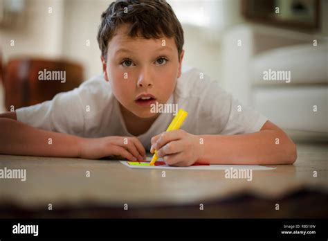 Boy Lying Down Coloring In Pictures Stock Photo Alamy