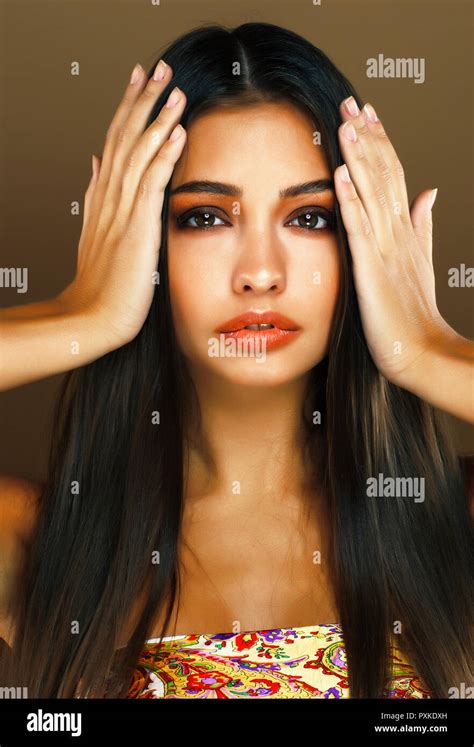 Young Pretty Indian Girl Posing Emotional On Brown Background L Stock