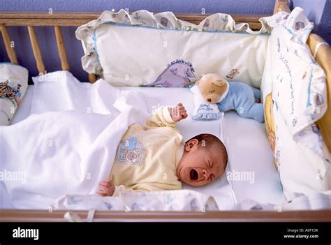 Small Baby Crying In Crib Stock Photo Alamy