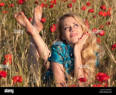 Beautiful Barefoot Blond Lady Laying In Poppy Field Stock Photo Alamy