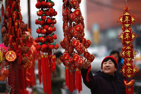 A Woman Looks At Traditional Decorations At A Market In Beijing China