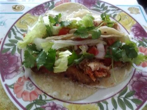 Maybe you would like to learn more about one of these? Fried tilapia fish taco topping with chopped cilantro ...