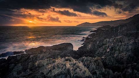 Rocks Sea Sunset Stones Clouds Sky Hd Wallpaper Peakpx