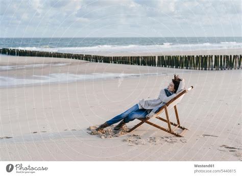 Woman Sitting On Deckchair On The Beach A Royalty Free Stock Photo From Photocase