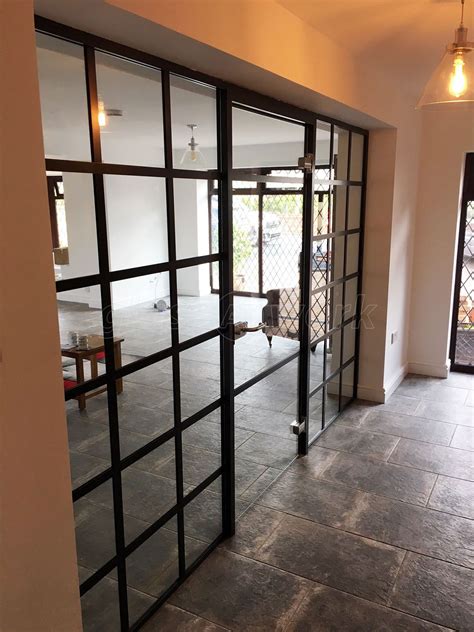 industrial heritage style black framed glazed partition wall for domestic project in stone