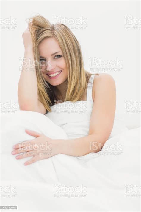 Portrait Of Beautiful Woman Sitting In Bed Stock Photo Download Image