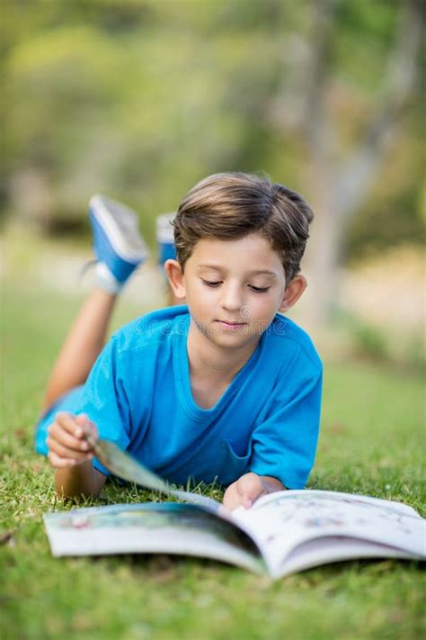 Young Boy Reading Book In Park Stock Photo Image Of Lying Parkland