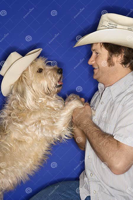 Dog And Man Wearing Cowboy Hats Stock Image Image Of Male Person