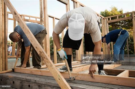 Construction Workers Building House Frame High Res Stock Photo Getty