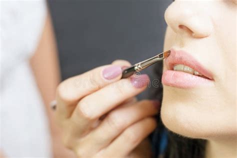 Closeup Specialist In Beauty Salon Gets Lipstick Lip Gloss Make Up