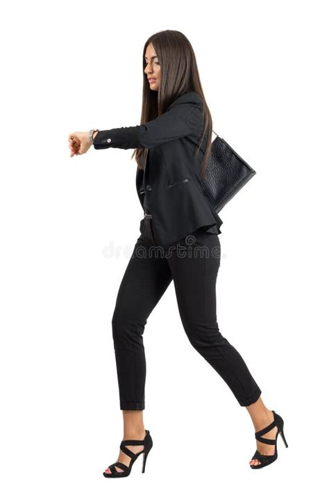 Young Attractive Businesswoman In Suit Running While Checking Time On