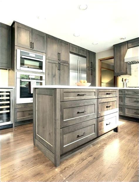 The oslo gray cabinets provide the perfect contrast between the light wood floors, white backsplash, and white ceiling. grey stained kitchen cabinets kitchen cabinets stain gray ...