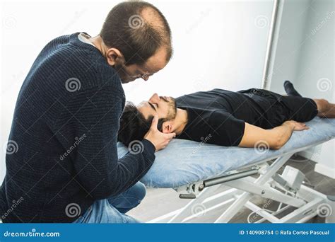 Physiotherapist Massaging A Young Man Neck Concept Of Physiotherapy And Rehabilitation Stock