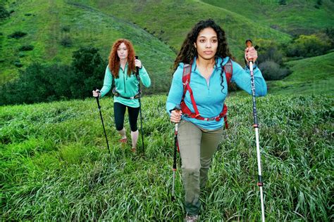 Serious Women Hiking With Walking Sticks Stock Photo Dissolve