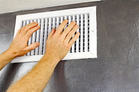 Two Hands In Front Of An Air Vent Stock Photo Download Image Now Istock