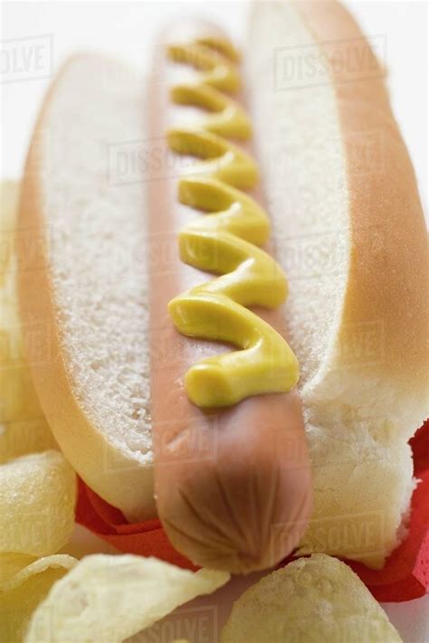 Hot Dog With Mustard And Potato Crisps Stock Photo Dissolve