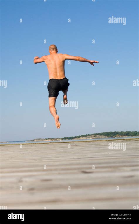 Stock Photography Of Rear View Of A Naked Man Jumping On A Beach With My XXX Hot Girl