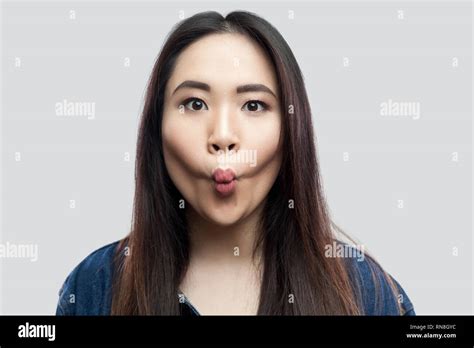 Portrait Of Funny Beautiful Brunette Asian Young Woman In Casual Blue Denim Jacket With Makeup